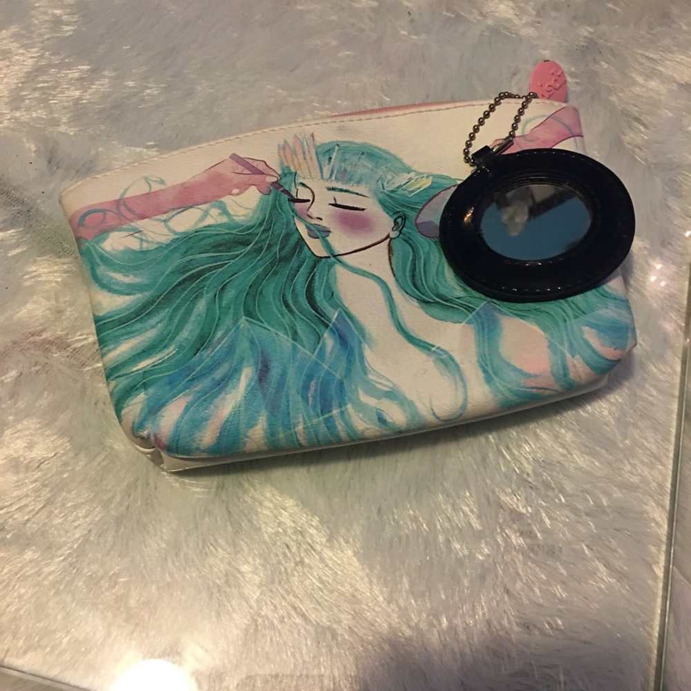 Ipsy small pouch w/ attacked circular mirror.